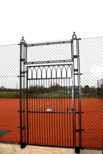 Gothic tennis court gate design by Elliott Courts - EnTC.