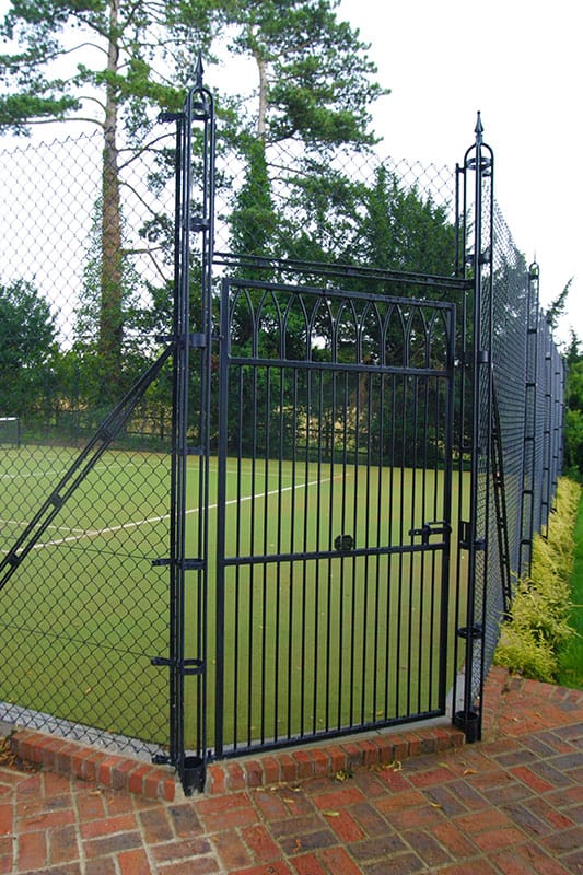 Gothic tennis court gate with a mitred corner - Elliott Courts.