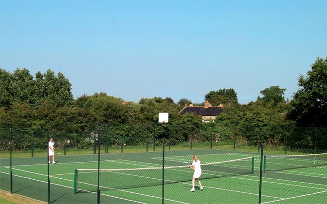 Tarmac tennis courts with a Pladek surface from Elliott Courts.